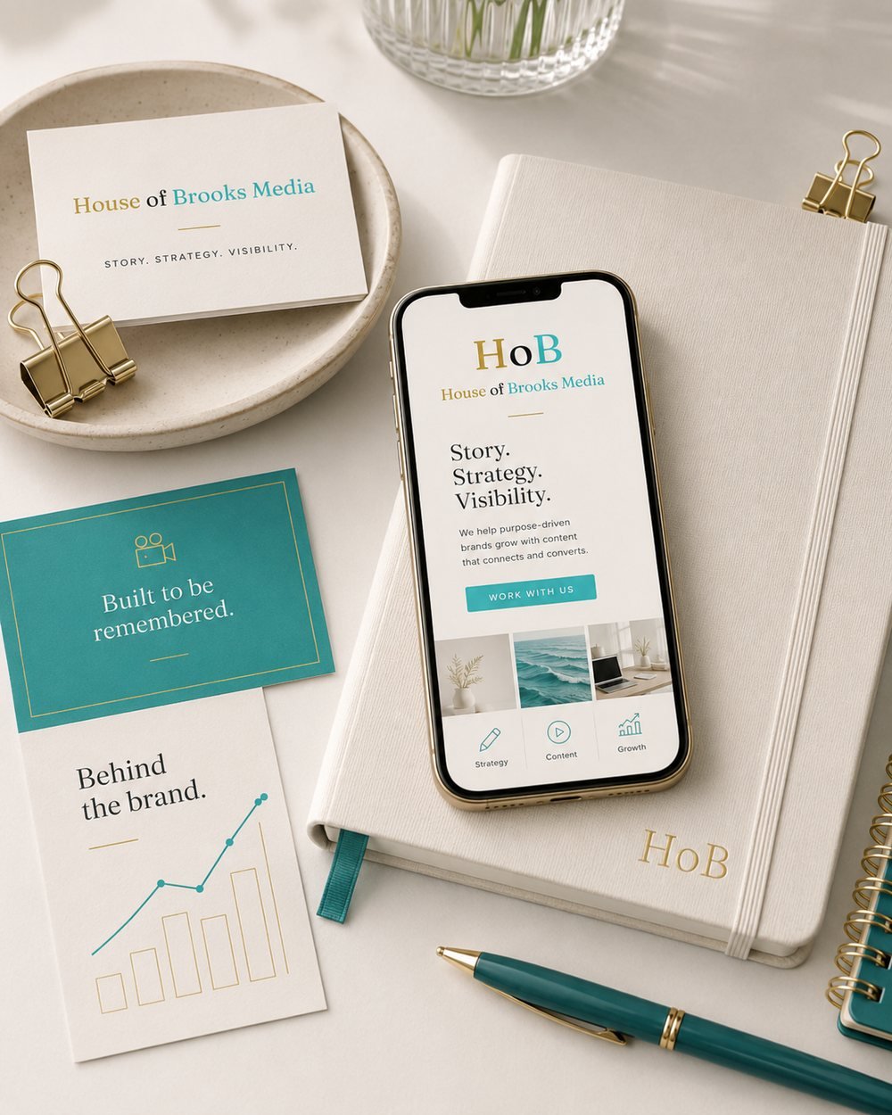 House of Brooks Media brand materials: a business card, notebook, and phone showing the site with the tagline story, strategy, visibility